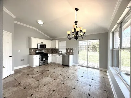 a view of a kitchen with a sink and cabinets