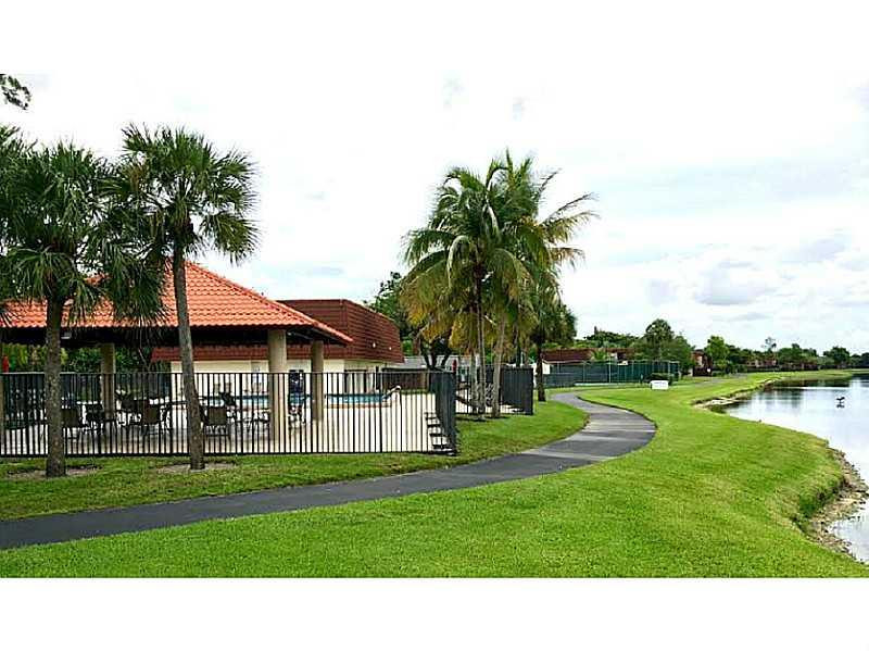 8509 Boca Rio Drive, Unit 8509 Boca Raton, FL 33433 - Photo 1 of 16 a view of a house with a big yard and palm trees