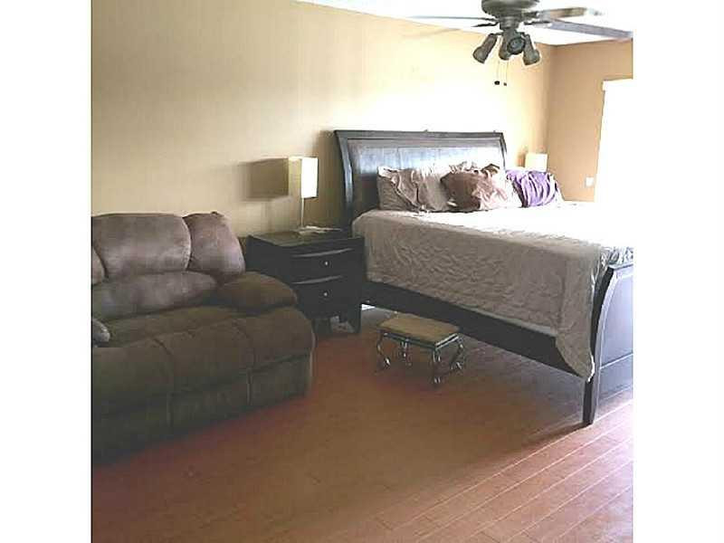 8509 Boca Rio Drive, Unit 8509 Boca Raton, FL 33433 - Photo 11 of 16 a bedroom with a bed and couch