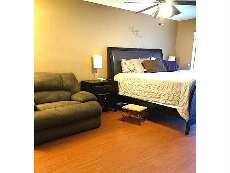 8509 Boca Rio Drive, Unit 8509 Boca Raton, FL 33433 - Photo 12 of 16 a bedroom with a bed and a couch