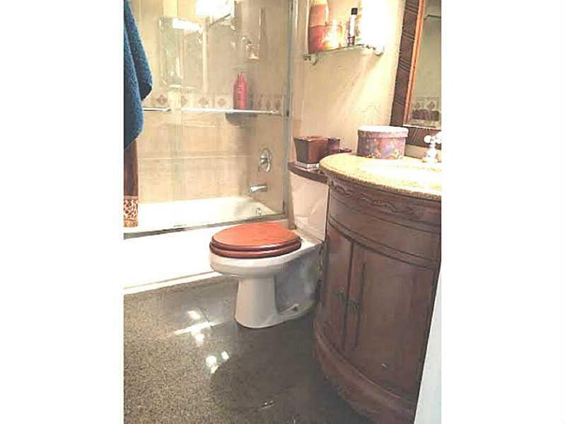 8509 Boca Rio Drive, Unit 8509 Boca Raton, FL 33433 - Photo 13 of 16 a bathroom with a sink and a toilet