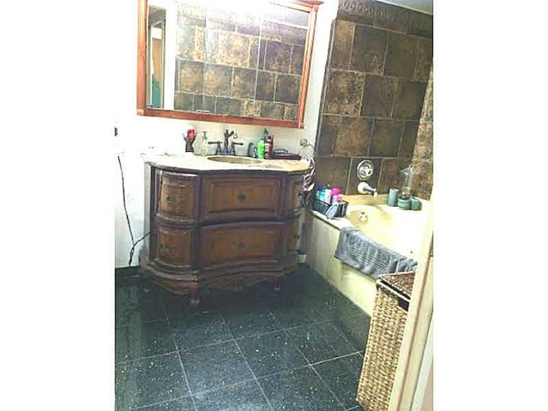 8509 Boca Rio Drive, Unit 8509 Boca Raton, FL 33433 - Photo 14 of 16 a bathroom with a sink and a mirror