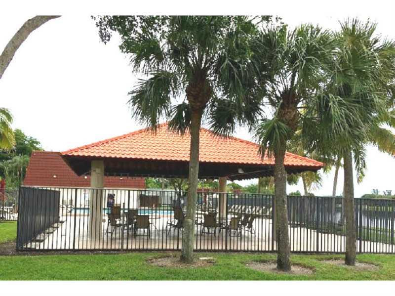 8509 Boca Rio Drive, Unit 8509 Boca Raton, FL 33433 - Photo 2 of 16 a front view of a house with a garden and trees