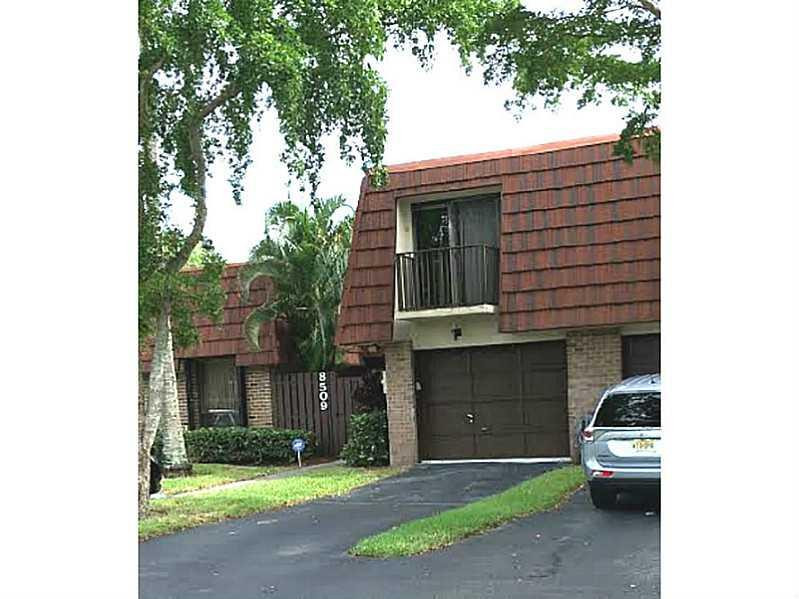 8509 Boca Rio Drive, Unit 8509 Boca Raton, FL 33433 - Photo 3 of 16 a front view of a house with a yard