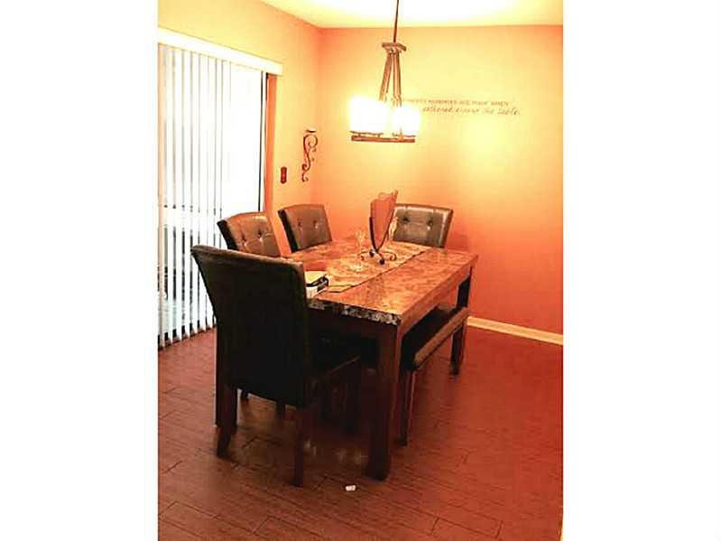 8509 Boca Rio Drive, Unit 8509 Boca Raton, FL 33433 - Photo 6 of 16 a dining room with furniture and wooden floor