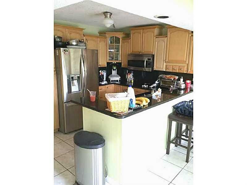 8509 Boca Rio Drive, Unit 8509 Boca Raton, FL 33433 - Photo 7 of 16 a kitchen with a sink and cabinets