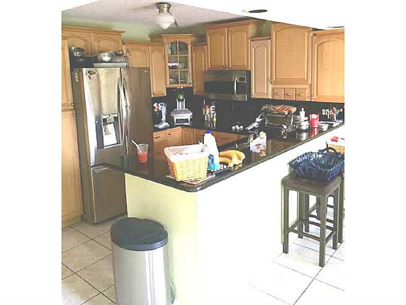 8509 Boca Rio Drive, Unit 8509 Boca Raton, FL 33433 - Photo 8 of 16 a kitchen with stainless steel appliances granite countertop a refrigerator and a sink