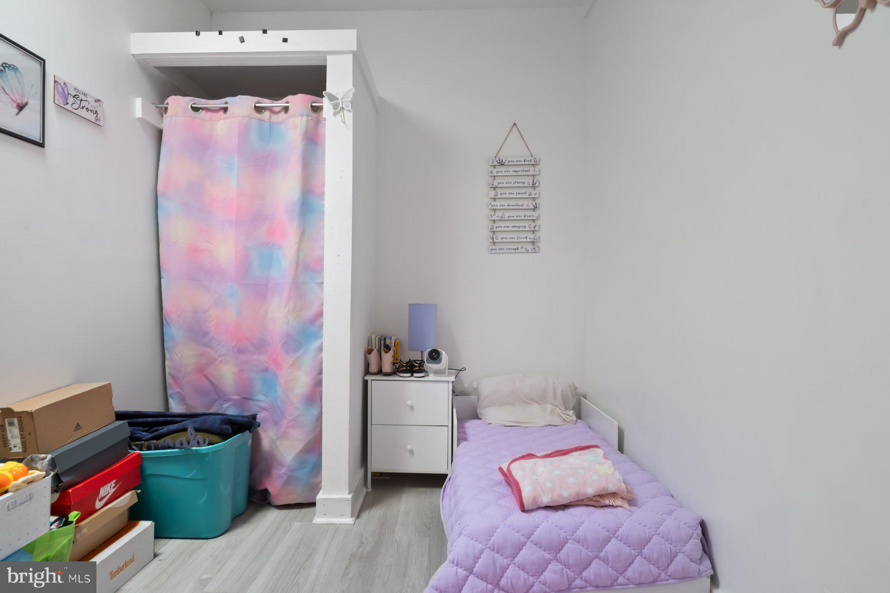 1659 Cliftview Avenue Baltimore, MD 21213 - Photo 15 of 25 a bedroom with a bed and a couch