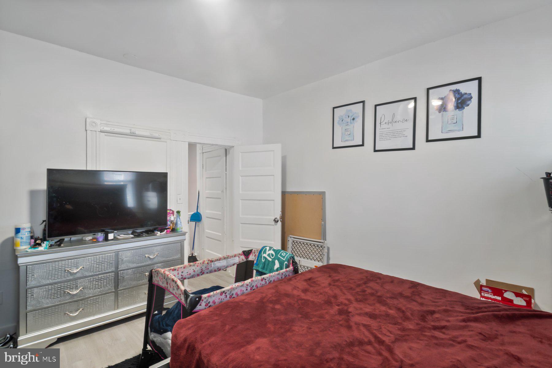 1659 Cliftview Avenue Baltimore, MD 21213 - Photo 20 of 25 a bedroom with a bed and a flat screen tv