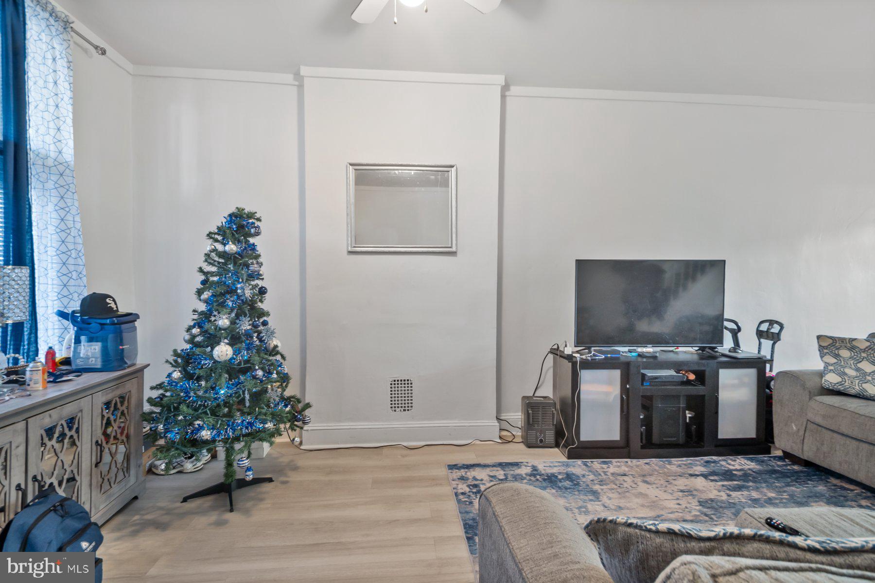 1659 Cliftview Avenue Baltimore, MD 21213 - Photo 4 of 25 a living room with furniture and a flat screen tv