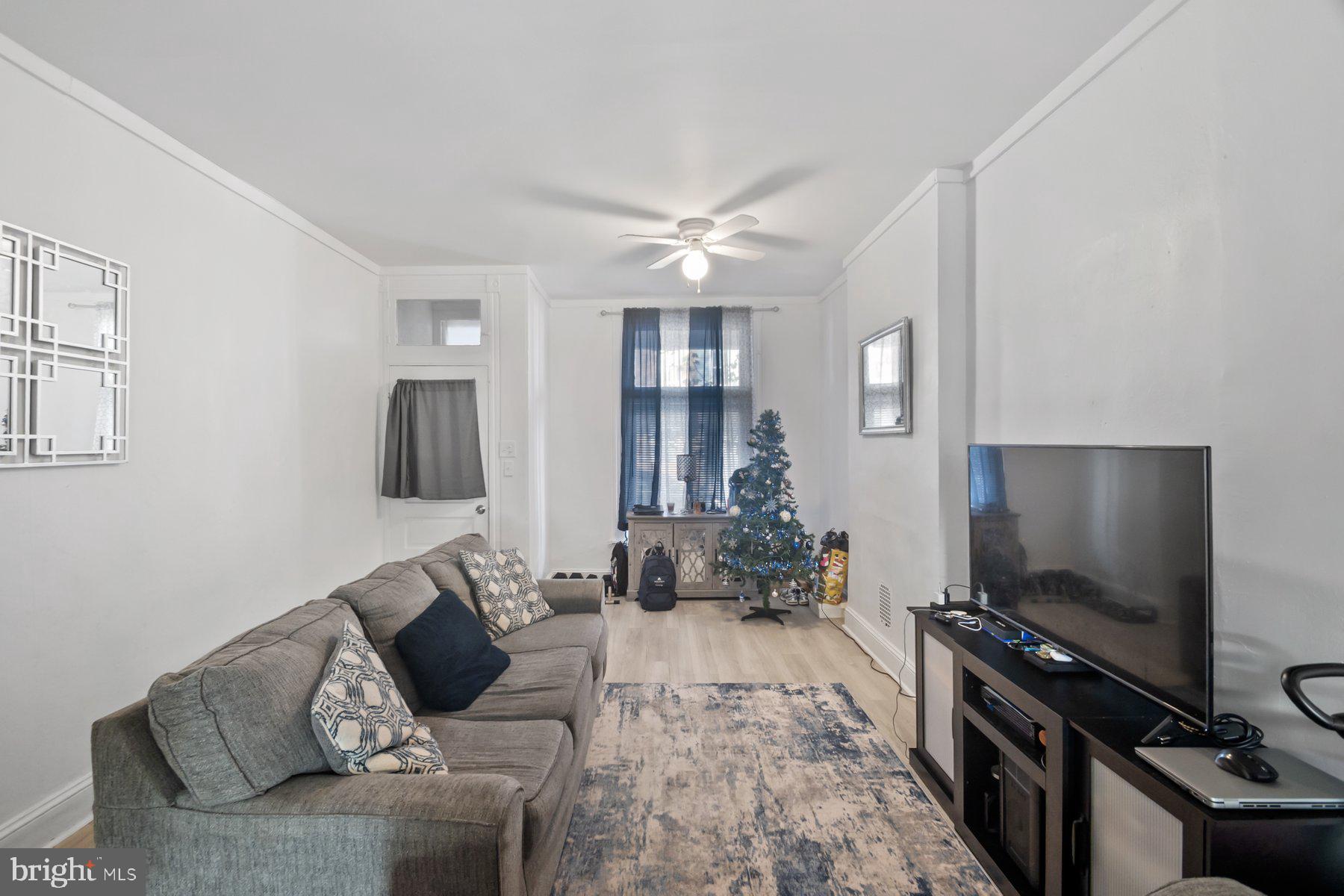 1659 Cliftview Avenue Baltimore, MD 21213 - Photo 5 of 25 a living room with furniture and a flat screen tv
