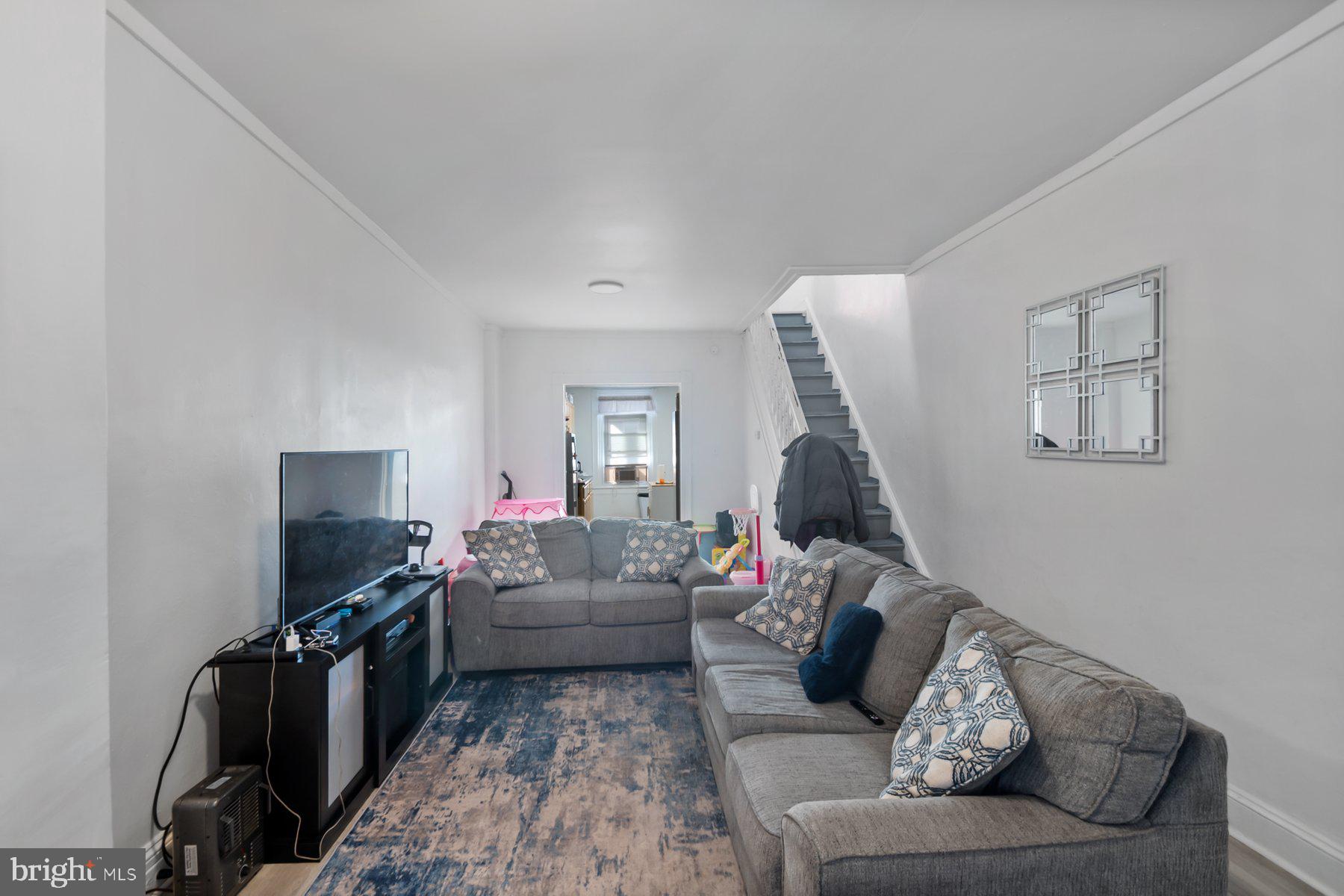 1659 Cliftview Avenue Baltimore, MD 21213 - Photo 6 of 25 a living room with furniture and a flat screen tv