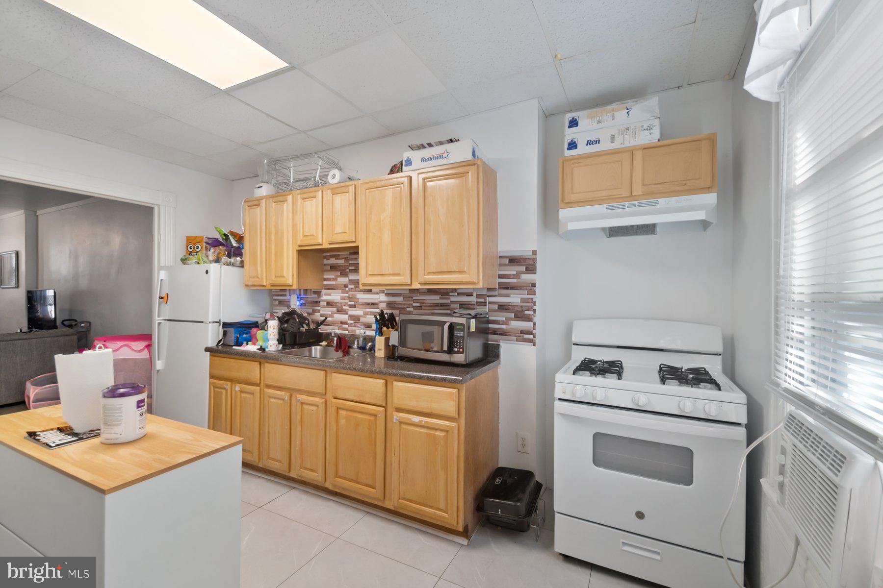 1659 Cliftview Avenue Baltimore, MD 21213 - Photo 10 of 25 a kitchen with a stove sink and cabinets