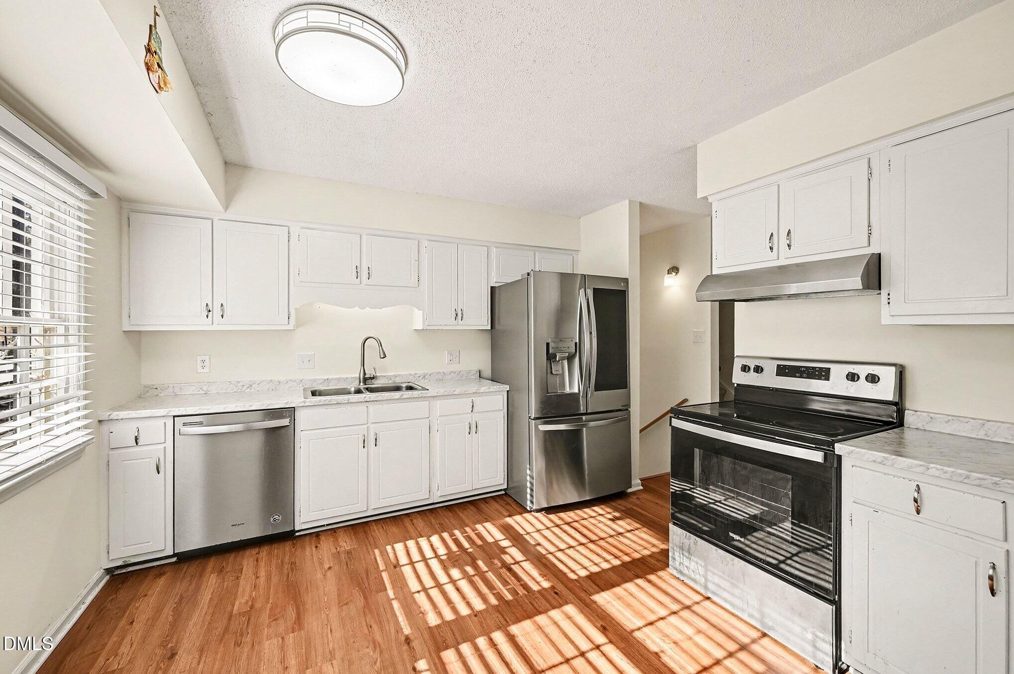 1920 White Plains Road Chapel Hill, NC 27517 - Photo 8 of 31 a kitchen with stainless steel appliances a stove a sink and a refrigerator