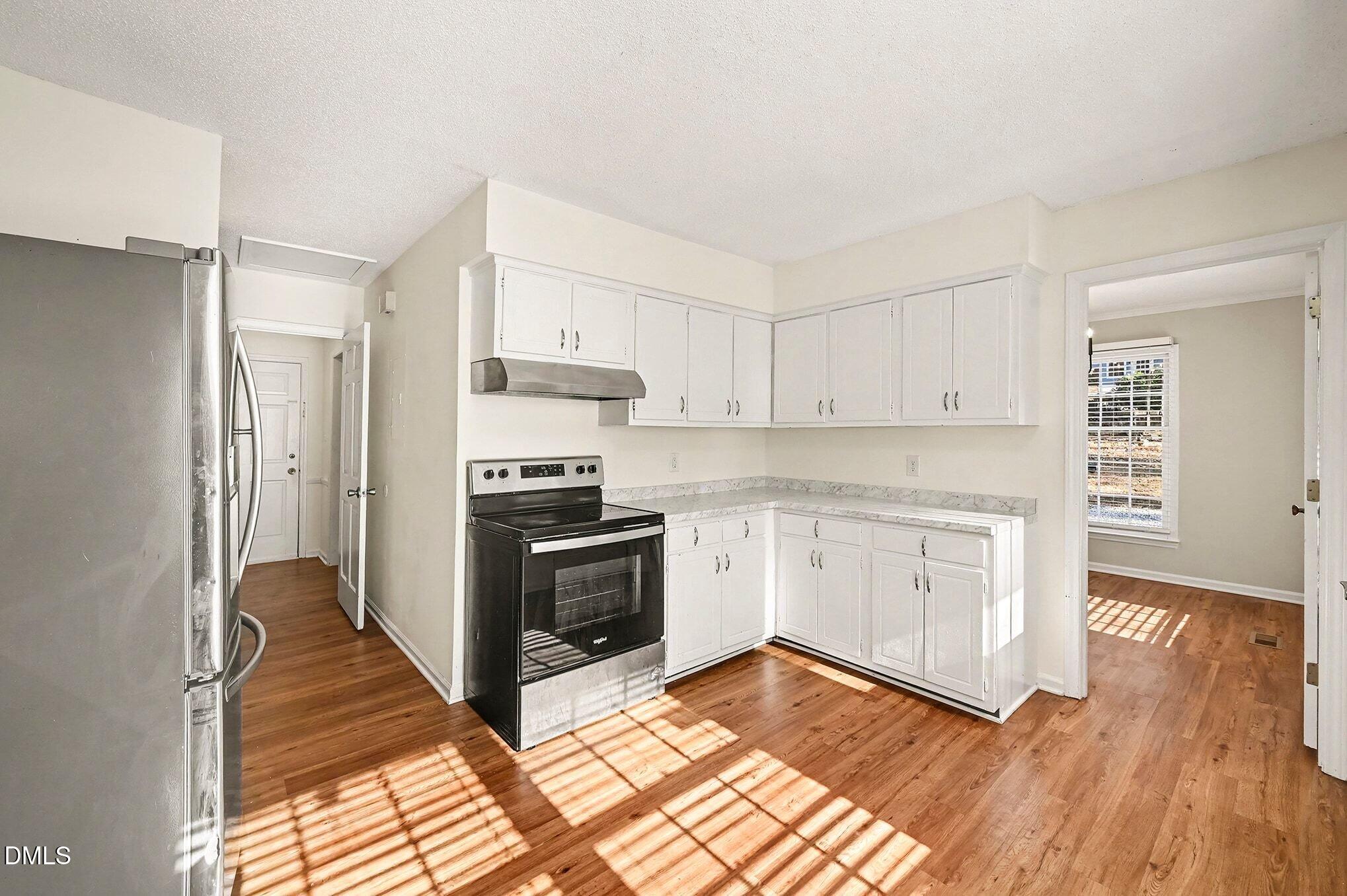 1920 White Plains Road Chapel Hill, NC 27517 - Photo 10 of 31 a kitchen with wooden floors and appliances