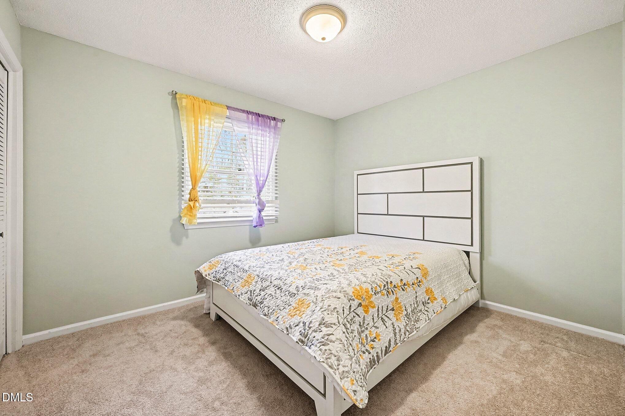 1920 White Plains Road Chapel Hill, NC 27517 - Photo 18 of 31 a bedroom with a bed and a window