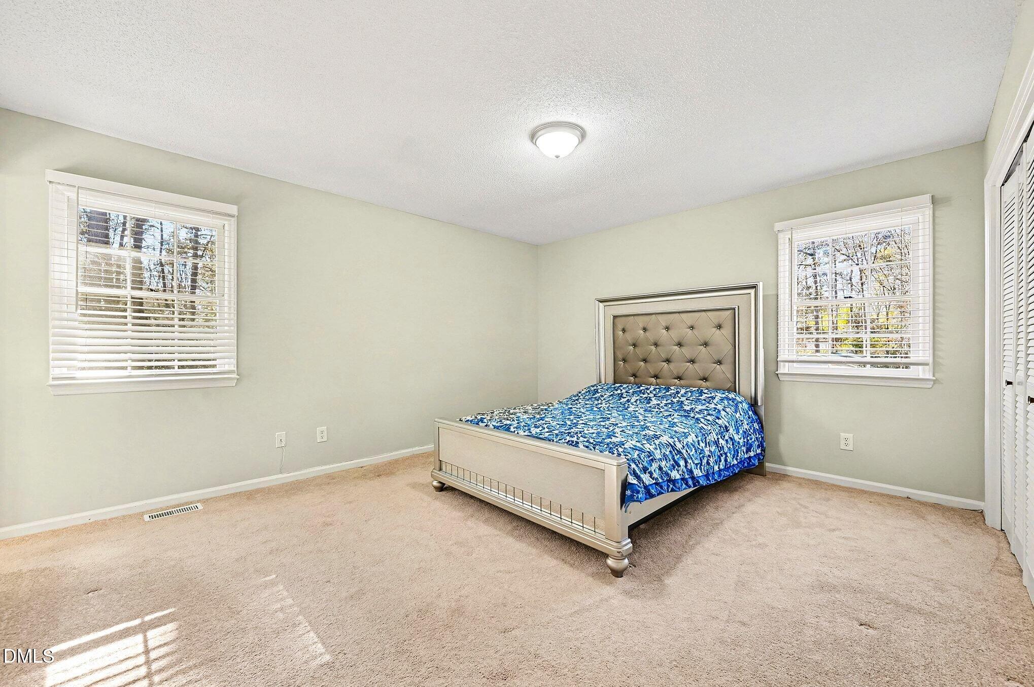 1920 White Plains Road Chapel Hill, NC 27517 - Photo 20 of 31 a bedroom with a bed lamp and window