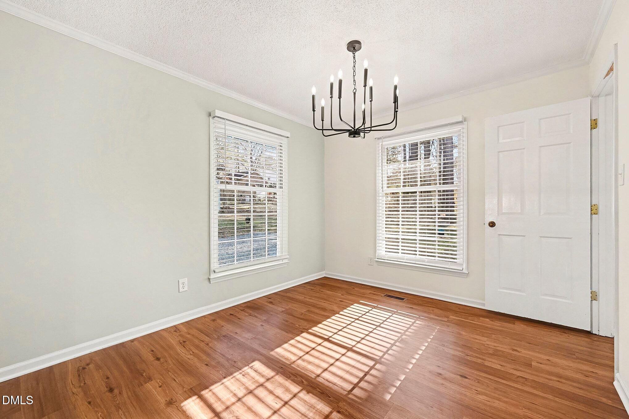1920 White Plains Road Chapel Hill, NC 27517 - Photo 7 of 31 a view of empty room with wooden floor and fan