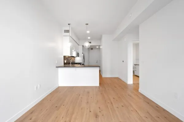 a view of a kitchen with wooden floor and a sink