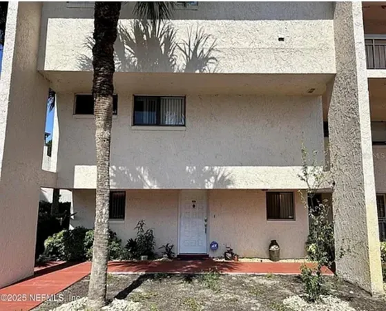 a backyard of a house with barbeque oven table and chairs