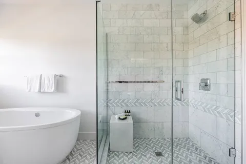 a bathroom with a bathtub and shower