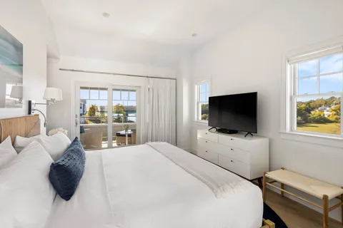 a bedroom with a bed and a flat screen tv