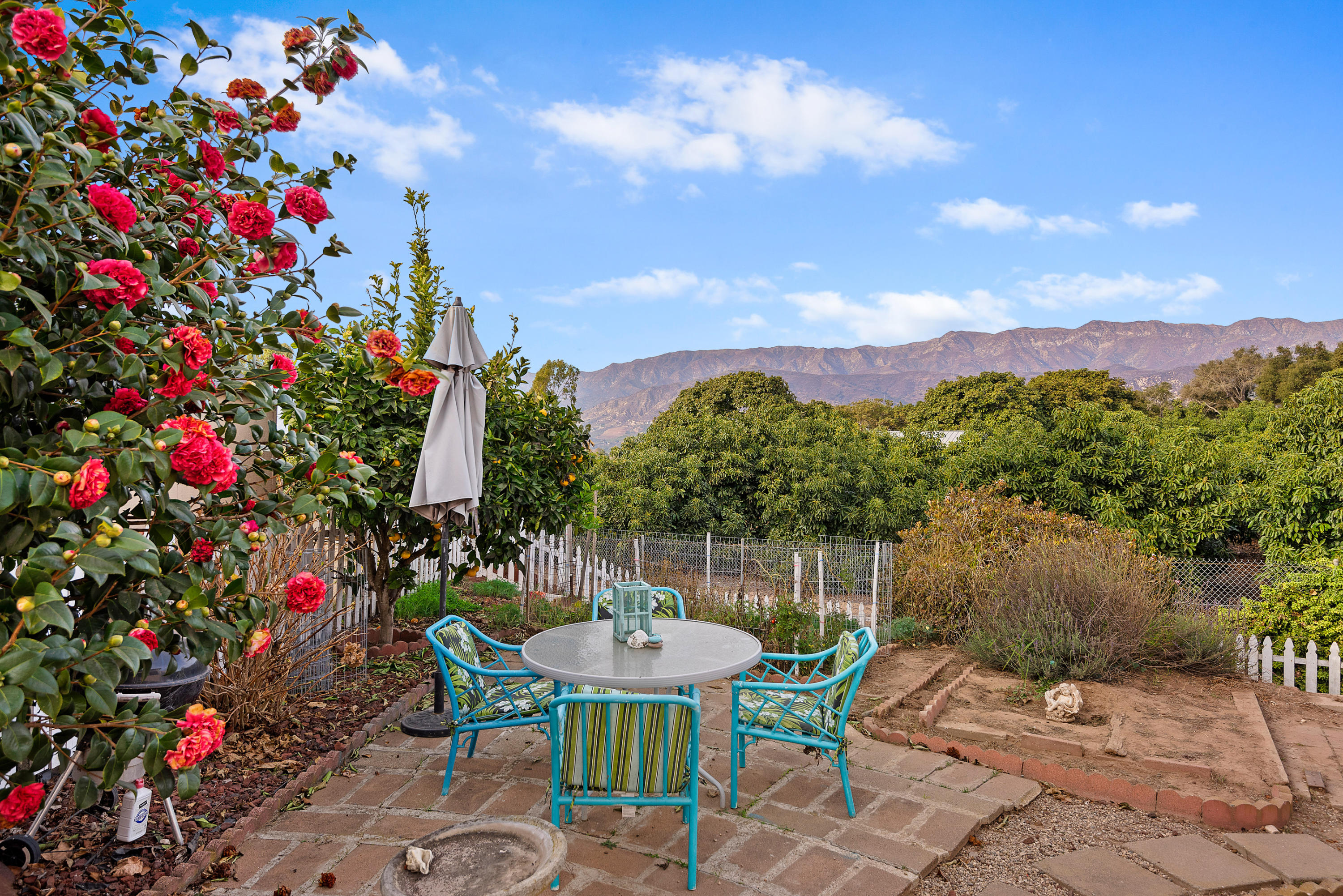 6180 Via Real, Unit 21 Carpinteria, CA 93013 - Photo 11 of 14 a view of a chairs and table in the backyard