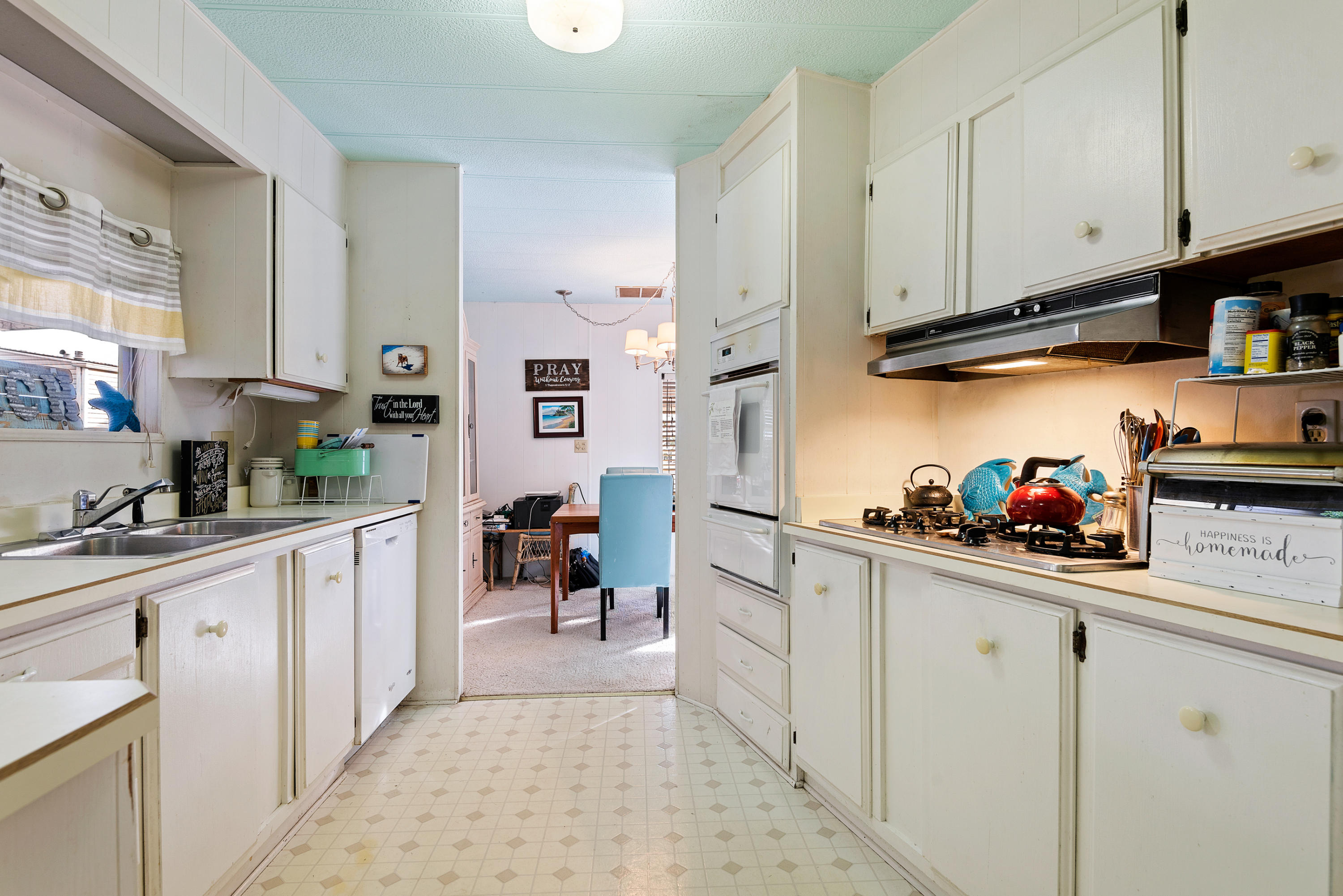 6180 Via Real, Unit 21 Carpinteria, CA 93013 - Photo 7 of 14 a kitchen with white cabinets and sink
