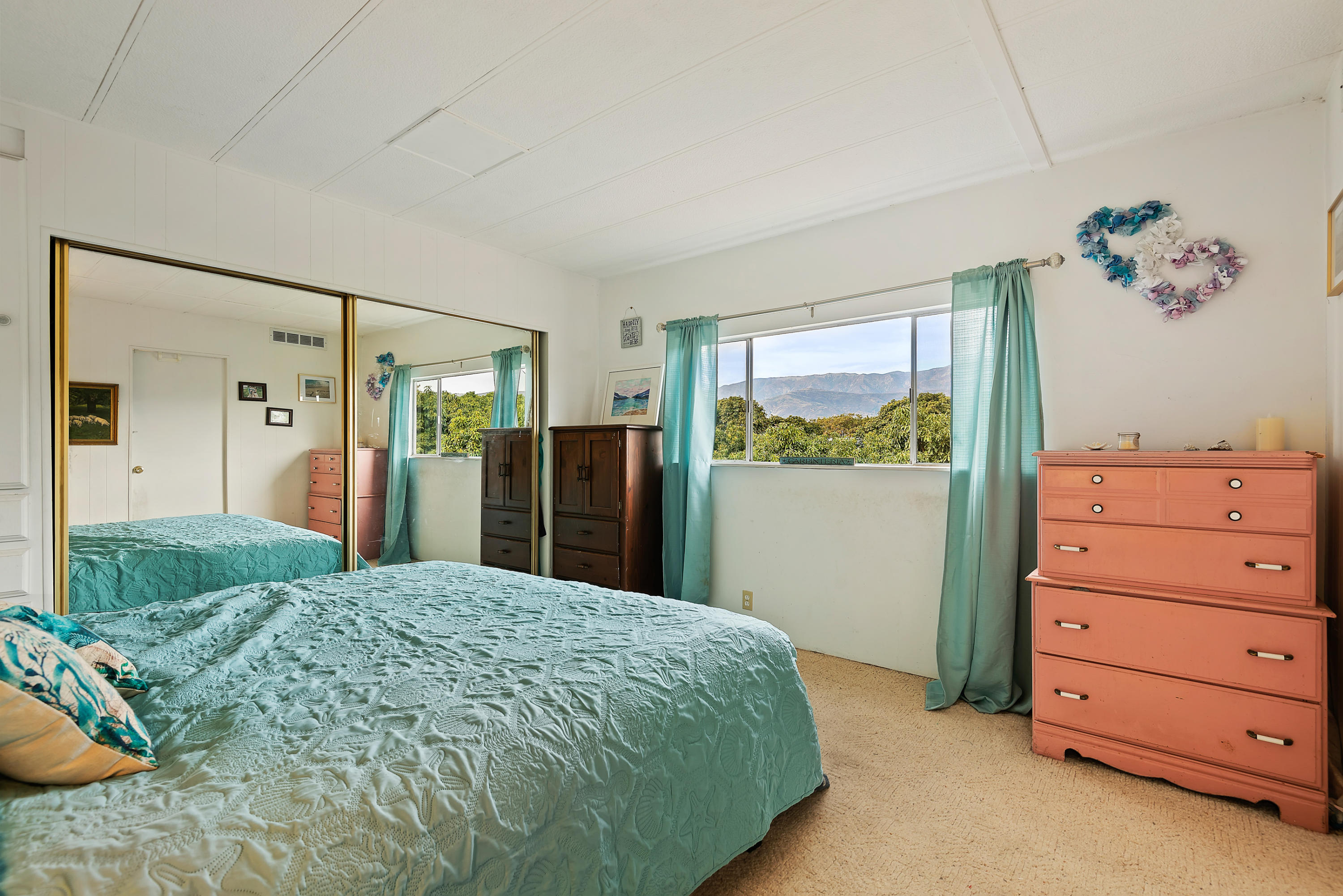 6180 Via Real, Unit 21 Carpinteria, CA 93013 - Photo 8 of 14 a bedroom with a bed and a dresser