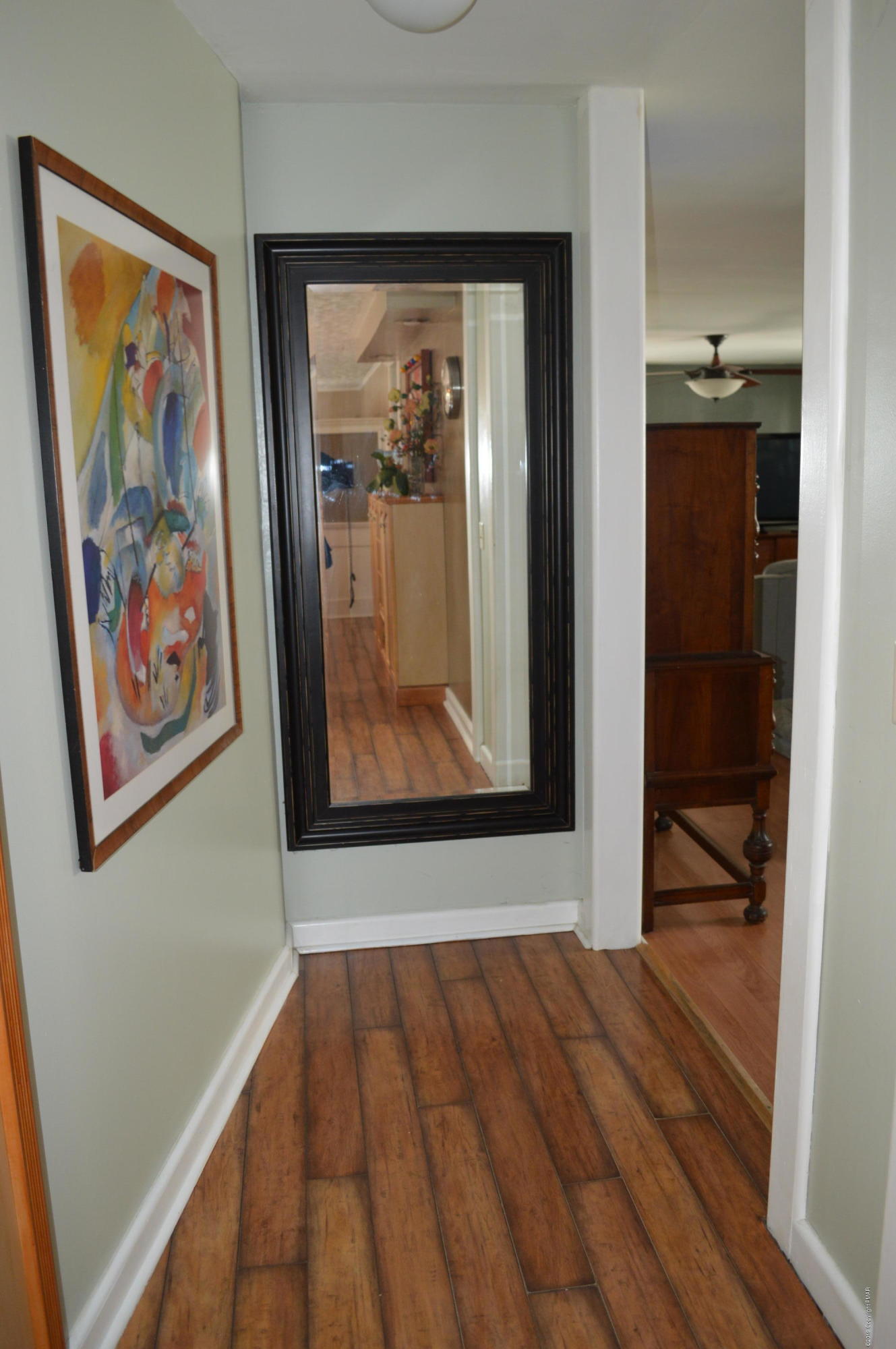 829 Gilbert Road Effort, PA 18330 - Photo 11 of 48 a view of a hallway with wooden floor and wall painting