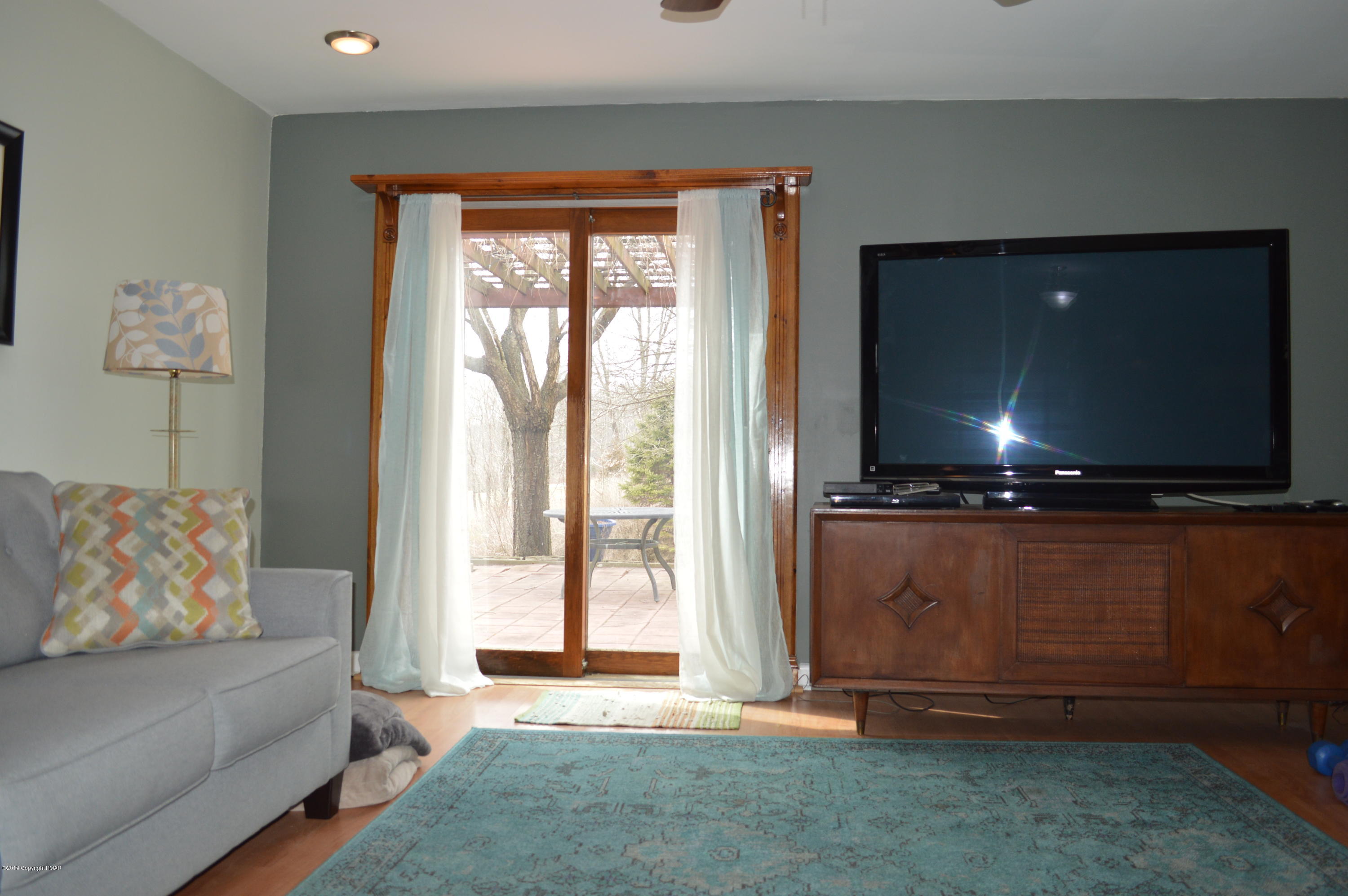 829 Gilbert Road Effort, PA 18330 - Photo 13 of 48 a living room with furniture and a flat screen tv