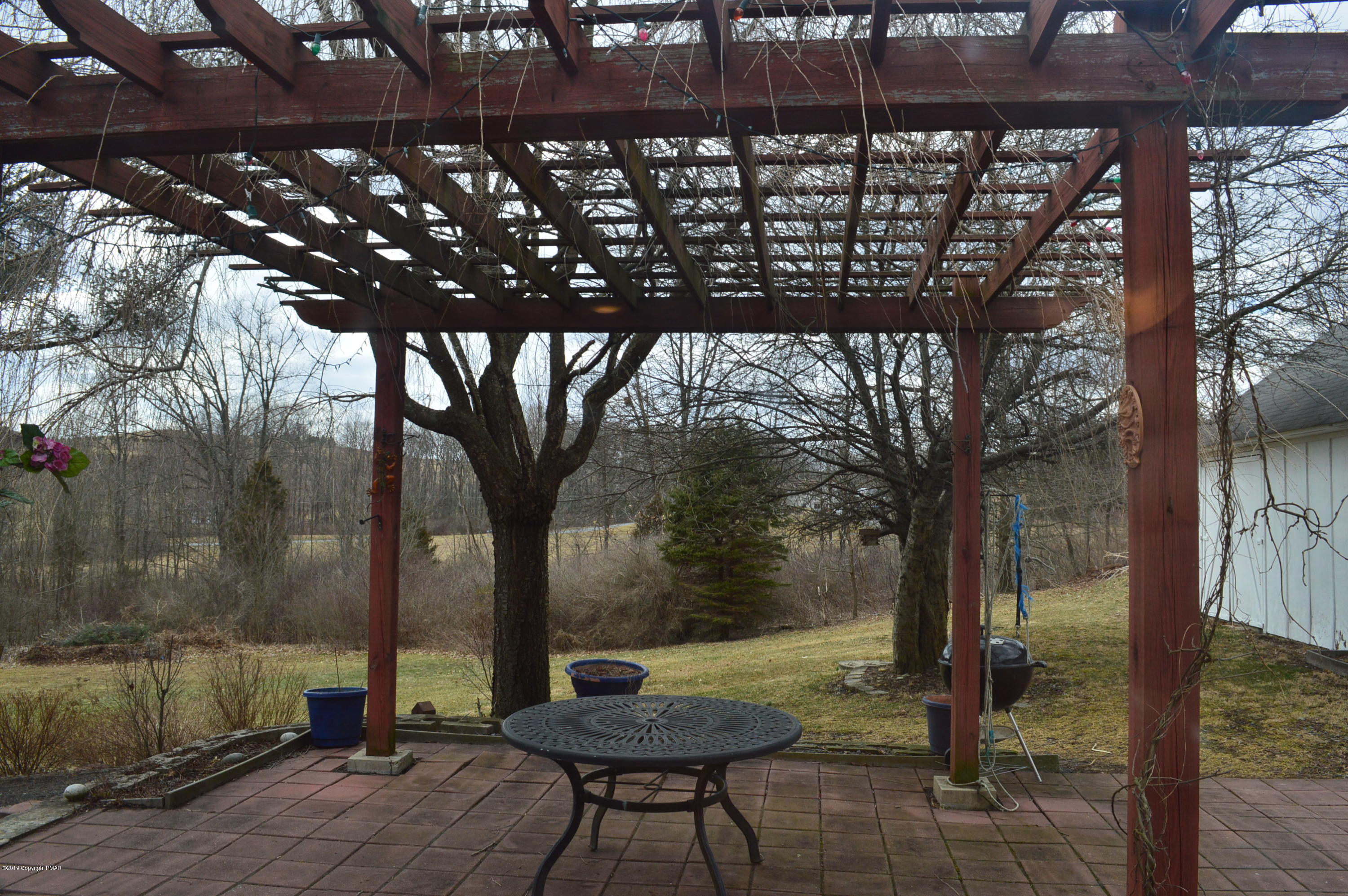 829 Gilbert Road Effort, PA 18330 - Photo 20 of 48 a backyard of a house with table and chairs
