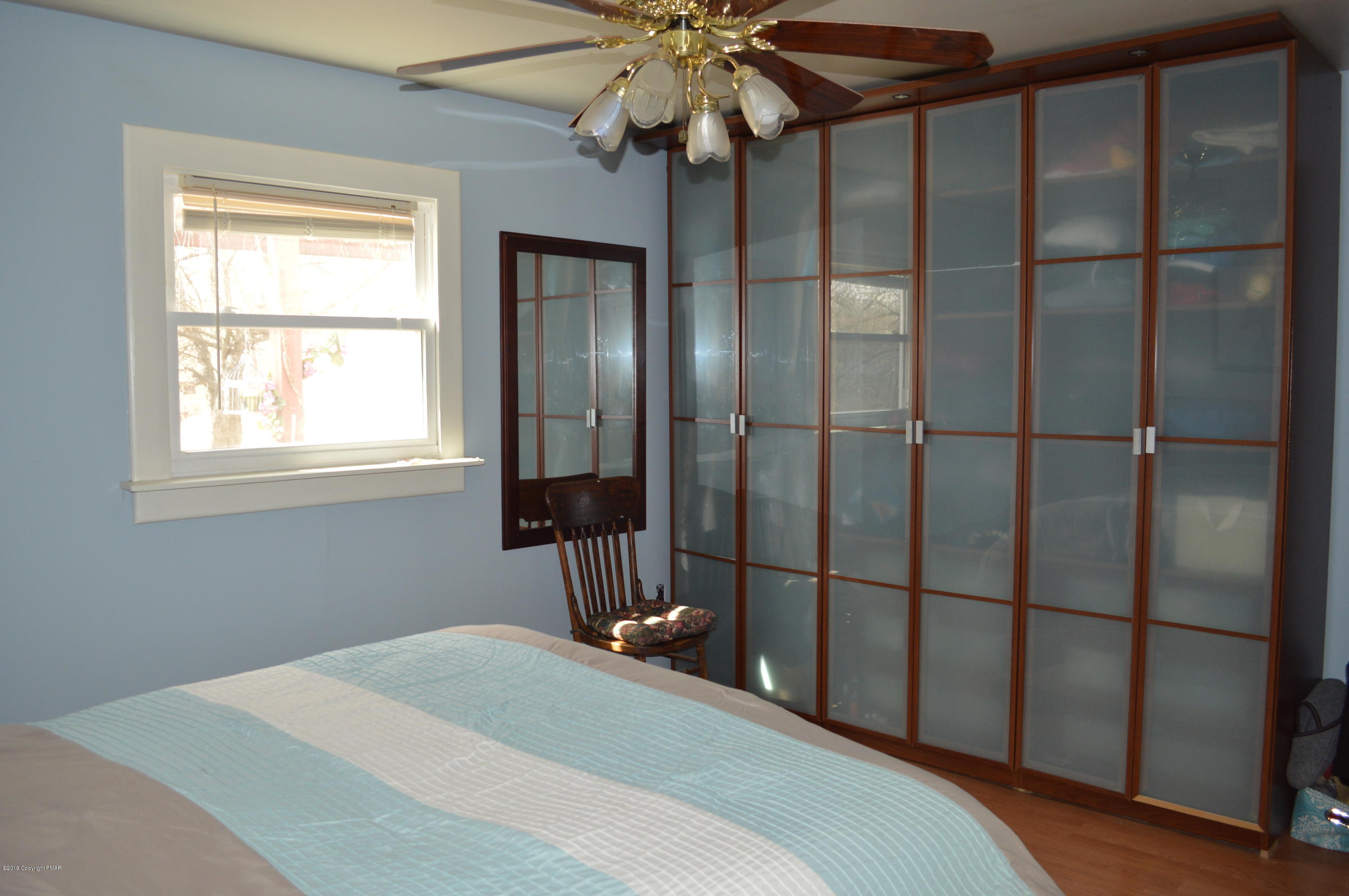 829 Gilbert Road Effort, PA 18330 - Photo 29 of 48 a bedroom with a bed and a chandelier