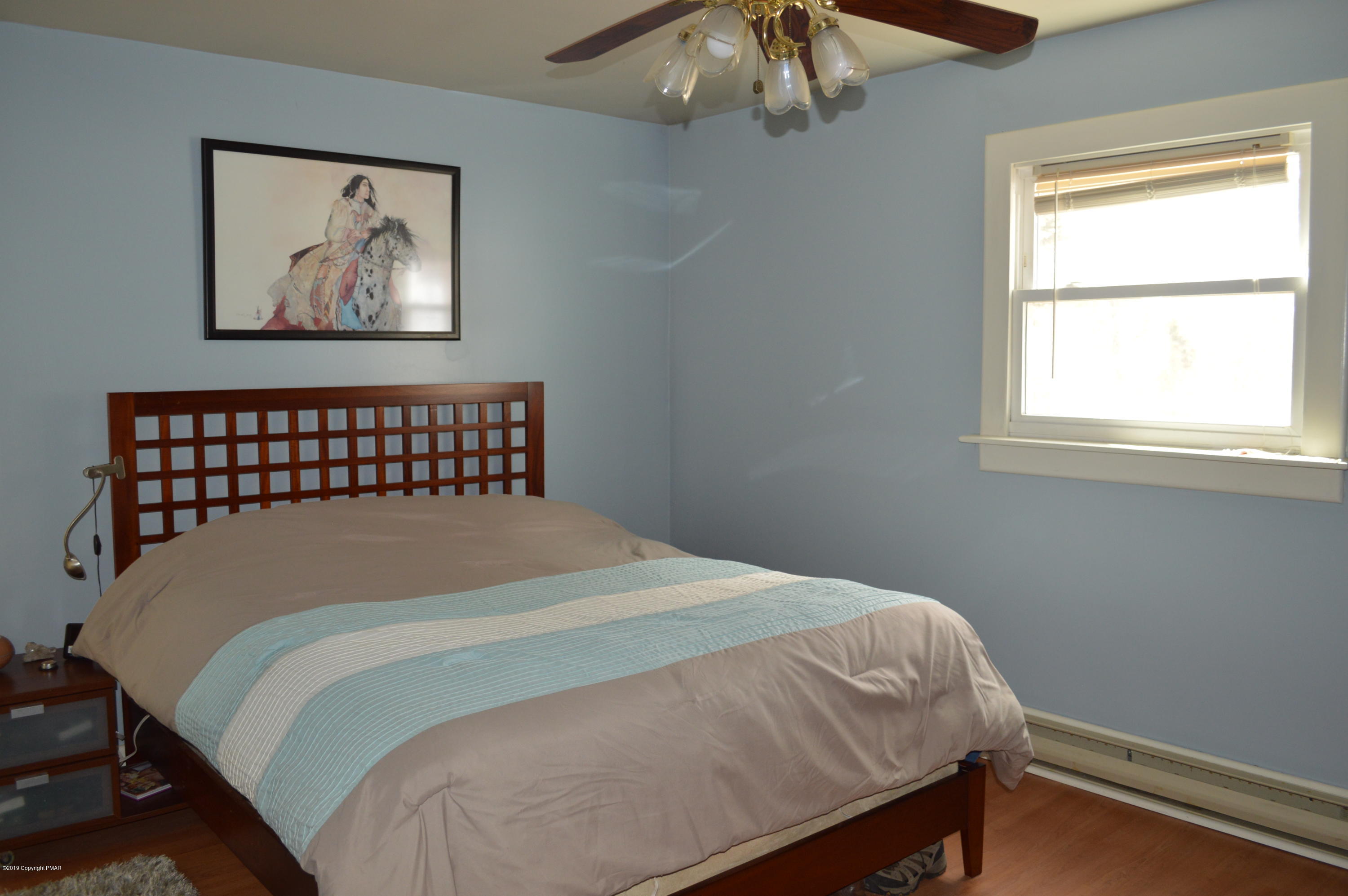 829 Gilbert Road Effort, PA 18330 - Photo 30 of 48 a bedroom with a bed and a painting on the wall