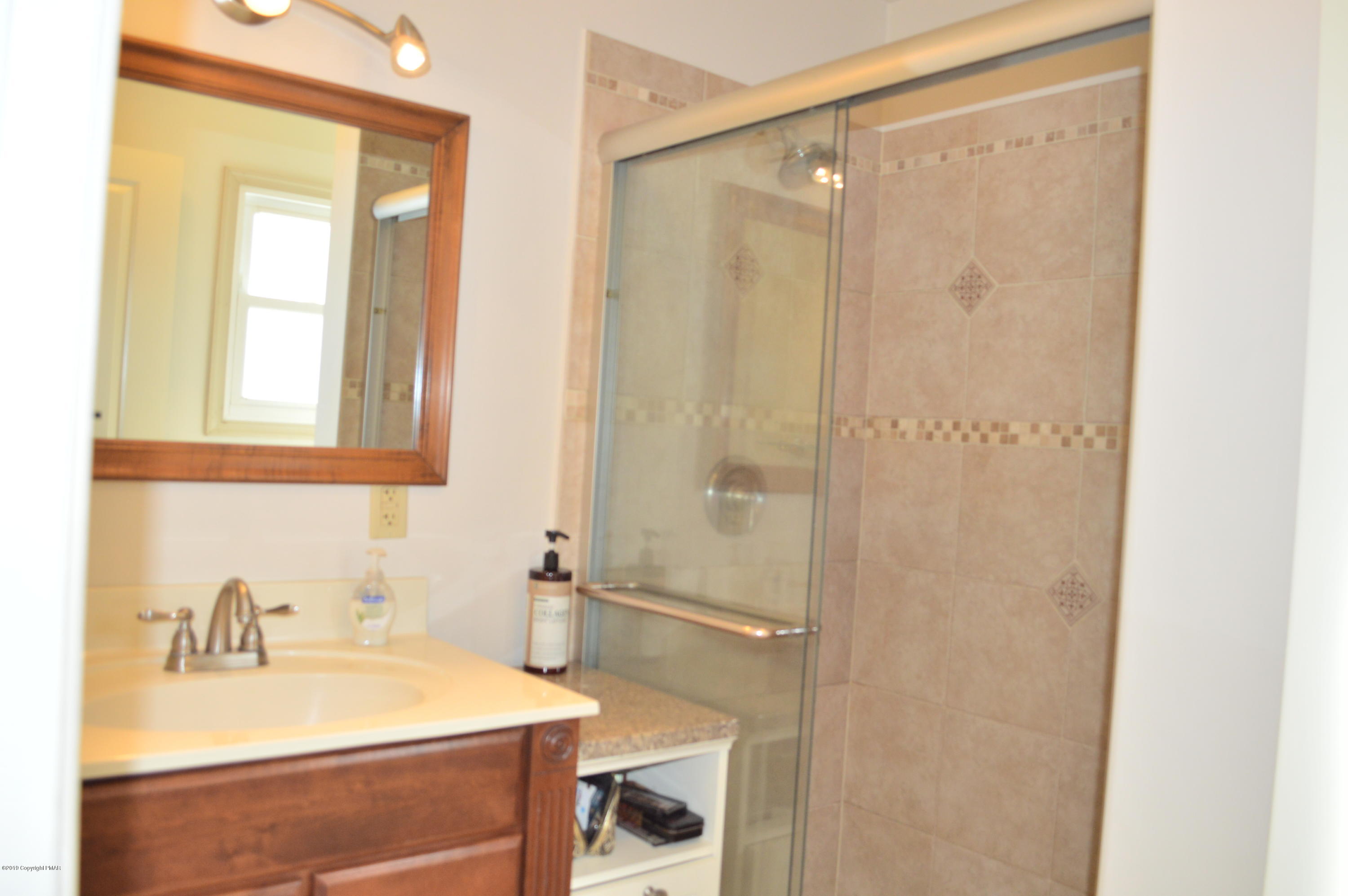 829 Gilbert Road Effort, PA 18330 - Photo 31 of 48 a bathroom with a sink and a mirror