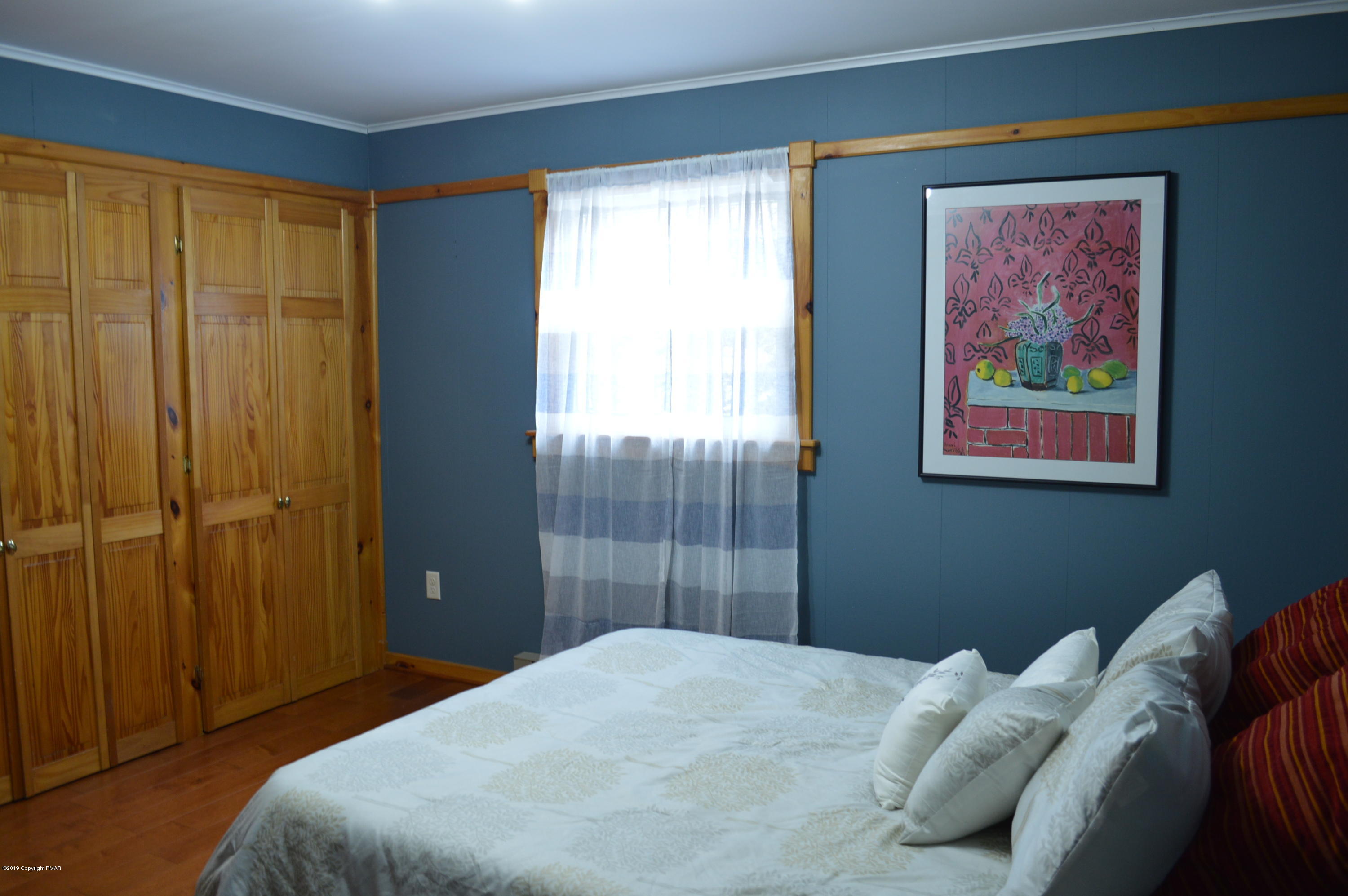 829 Gilbert Road Effort, PA 18330 - Photo 33 of 48 a bedroom with a bed and a painting on the wall