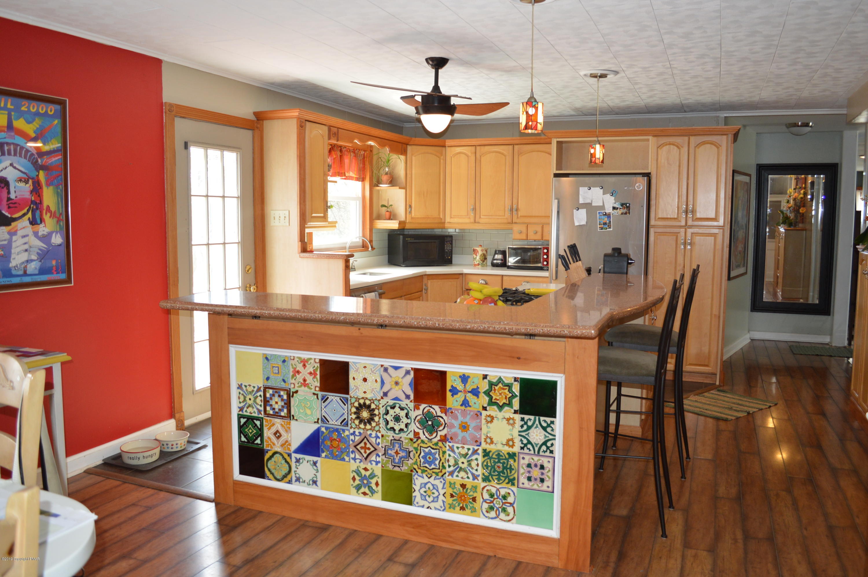 829 Gilbert Road Effort, PA 18330 - Photo 3 of 48 a view of a dining room with furniture a chandelier and wooden floor