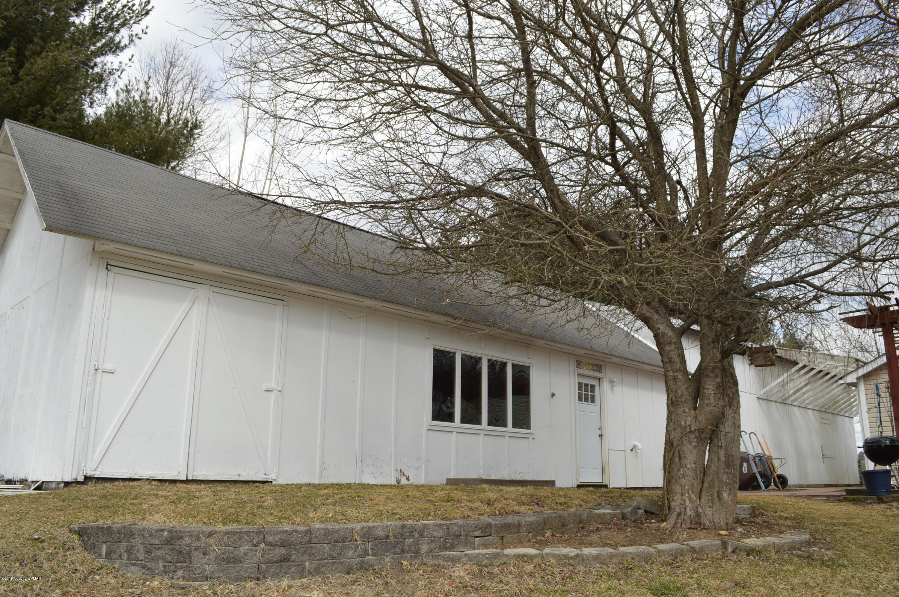 829 Gilbert Road Effort, PA 18330 - Photo 42 of 48 a house that has a tree in front of it