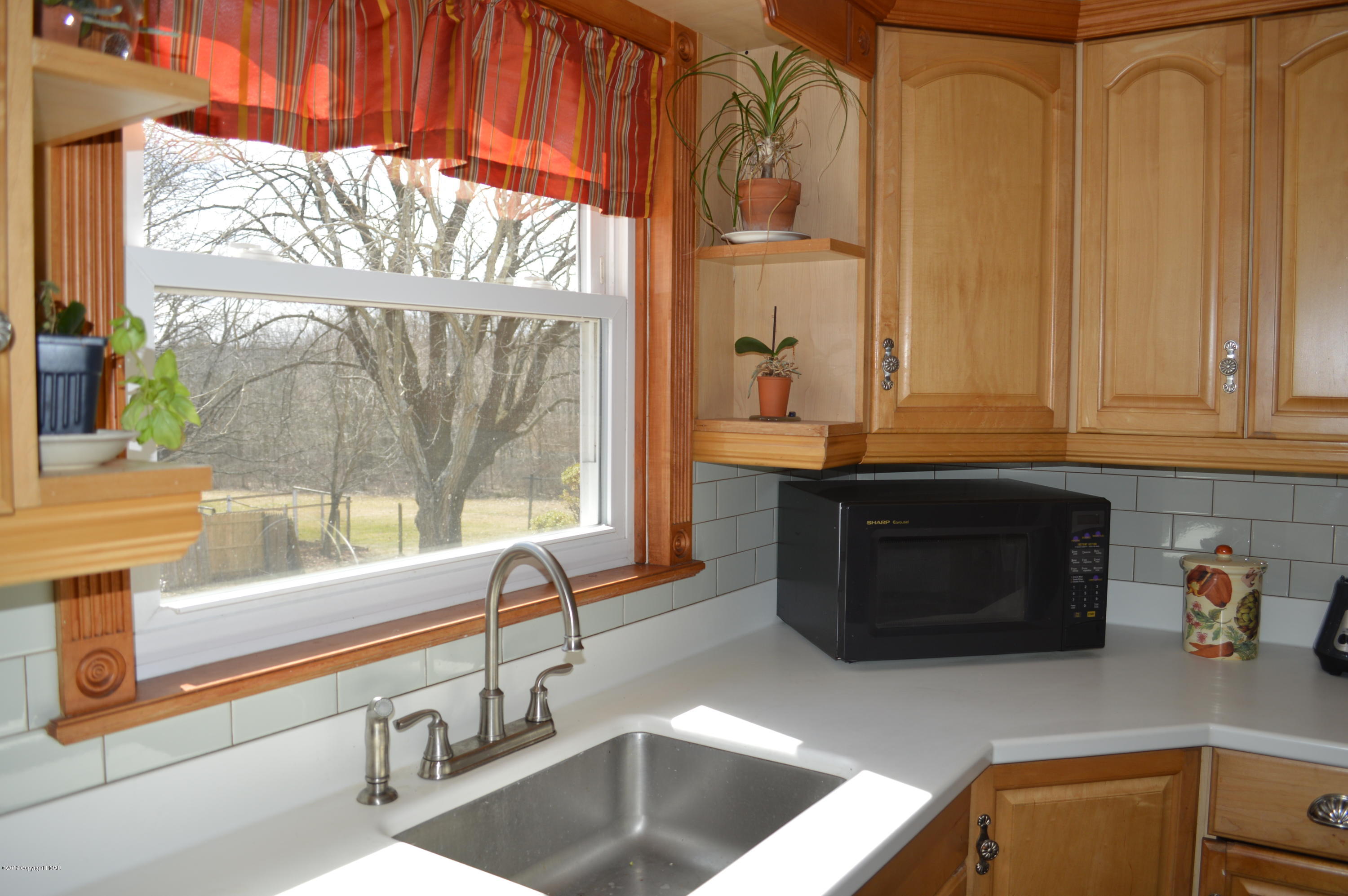 829 Gilbert Road Effort, PA 18330 - Photo 6 of 48 a kitchen with stainless steel appliances wooden cabinets and a large window