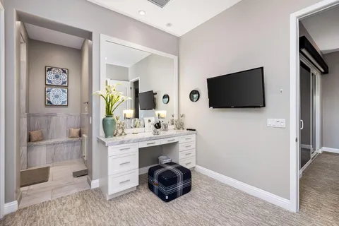 a spacious bedroom with a bed and a large window