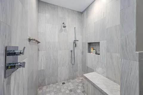 a bathroom with a granite countertop sink toilet and shower