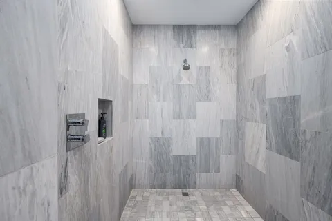 a bathroom with a double vanity sink toilet and shower
