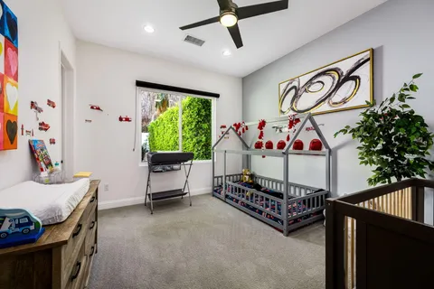 a living room with furniture potted plant a fireplace and a large window