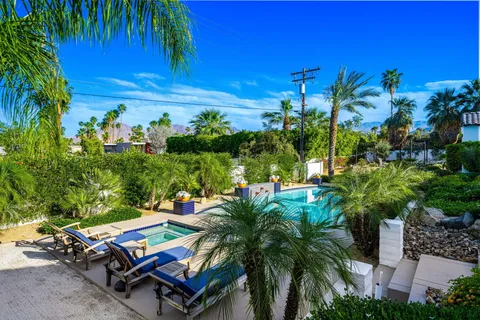 a view of a swimming pool with lounge chairs