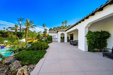 a view of a fountain in front of a house with a yard