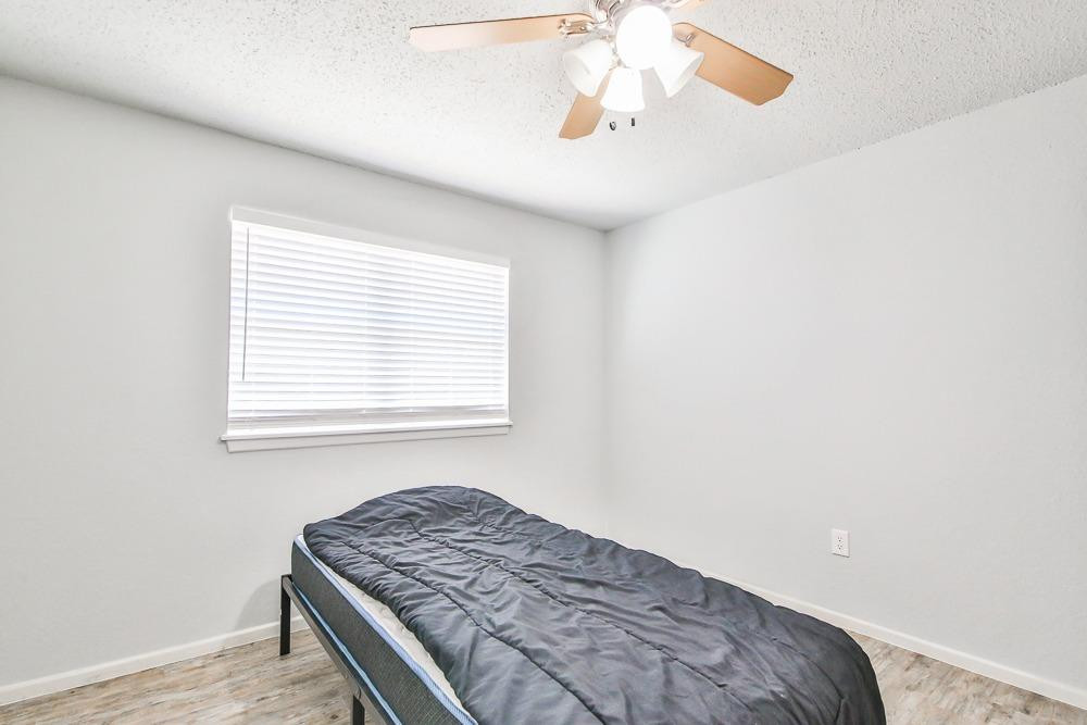 5503 1st Place Lubbock, TX 79416 - Photo 11 of 27 a bedroom with a bed and a window
