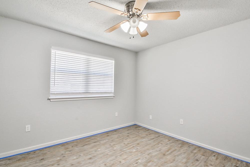 5503 1st Place Lubbock, TX 79416 - Photo 15 of 27 an empty room with a window and a fan