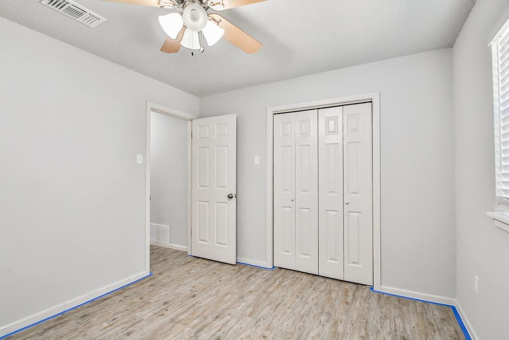 5503 1st Place Lubbock, TX 79416 - Photo 17 of 27 a view of an empty room with wooden floor