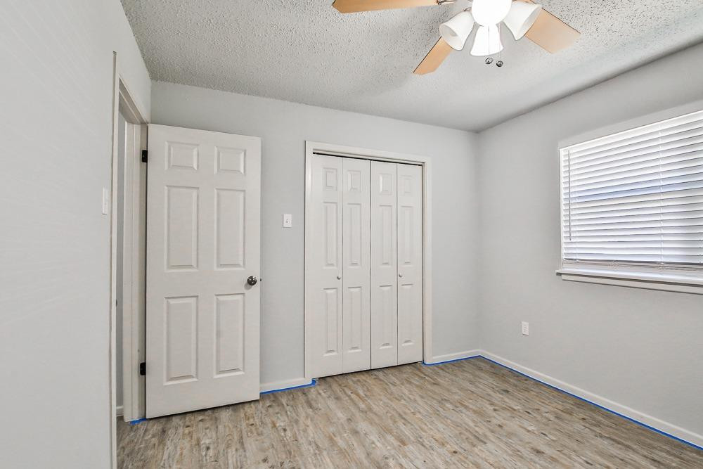 5503 1st Place Lubbock, TX 79416 - Photo 18 of 27 wooden floor in an empty room with a window