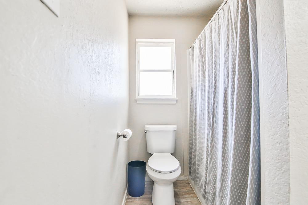 5503 1st Place Lubbock, TX 79416 - Photo 25 of 27 a white toilet sitting next to a window